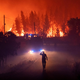 Members of the emergency services try to extinguish a wildfire near Cardigos village, in central Portugal on Sunday, July 21, 2019.